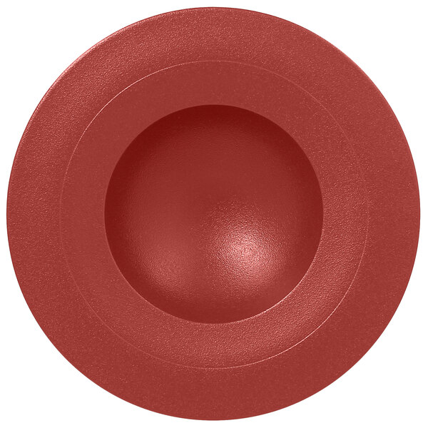 A red circular RAK Porcelain deep plate with a circle in the middle.