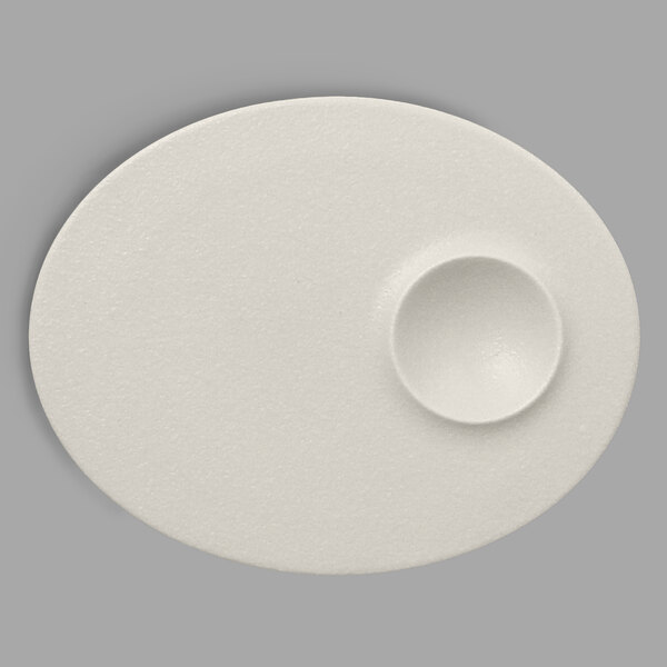 A white oval RAK Porcelain plate with a small hole in the middle.
