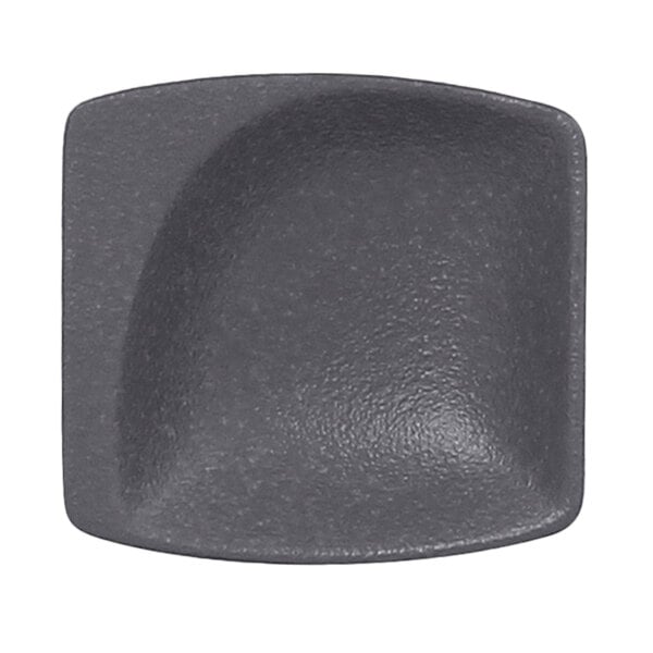 A black square plate with a curved edge.