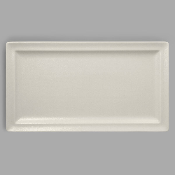 A rectangular white plate on a white surface.