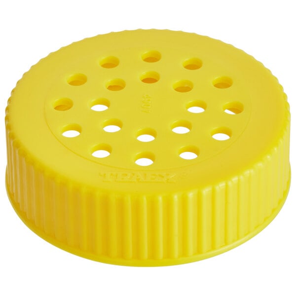 A yellow plastic Vollrath Dripcut lid with holes.