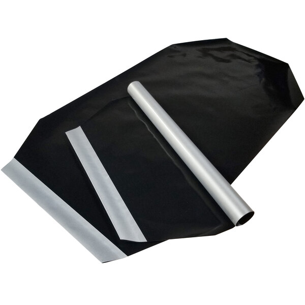 A black plastic bag containing white and silver 31 1/2" x 17 1/2" PTFE non-stick release sheets.