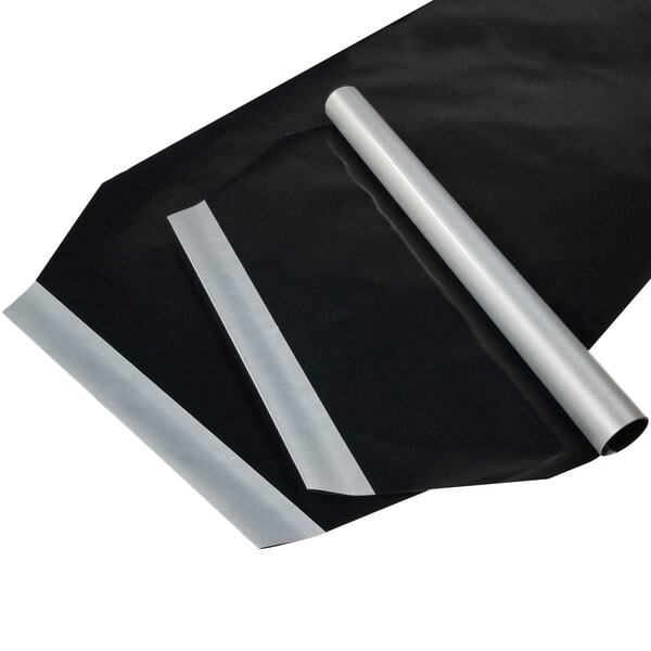 A roll of black plastic sheets with silver metal strips.