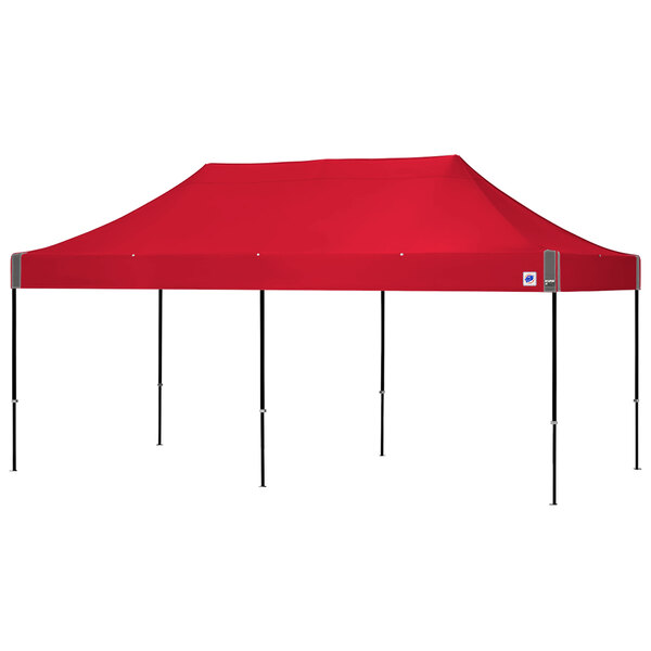 A red tent with black poles in a red bag with a white tag.