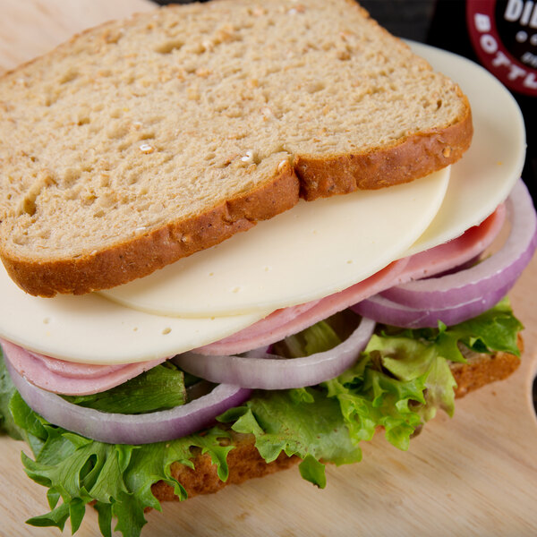 A sandwich with meat and mild provolone cheese on white background.