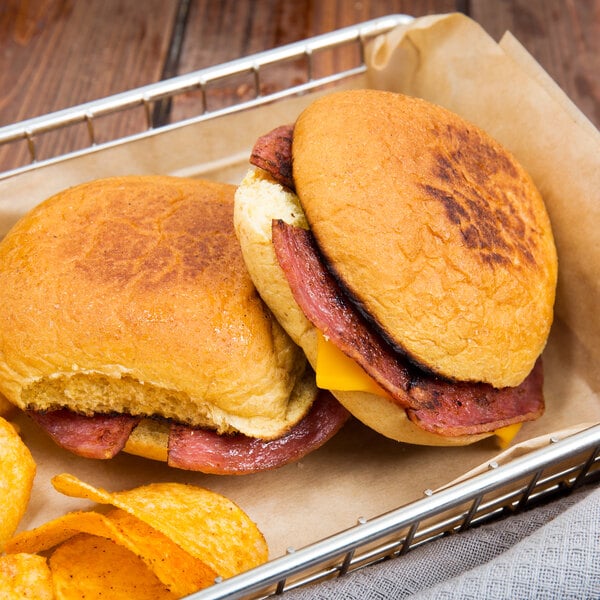 A basket with two sandwiches made with Taylor Pork Roll and chips.