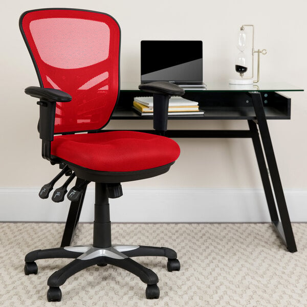 A red Flash Furniture office chair next to a black desk with a laptop on it.