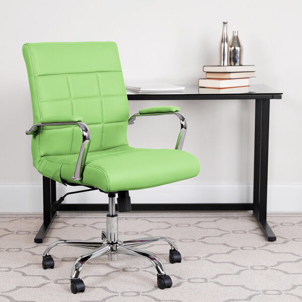 A green Flash Furniture mid-back office chair with chrome legs in front of a black desk.