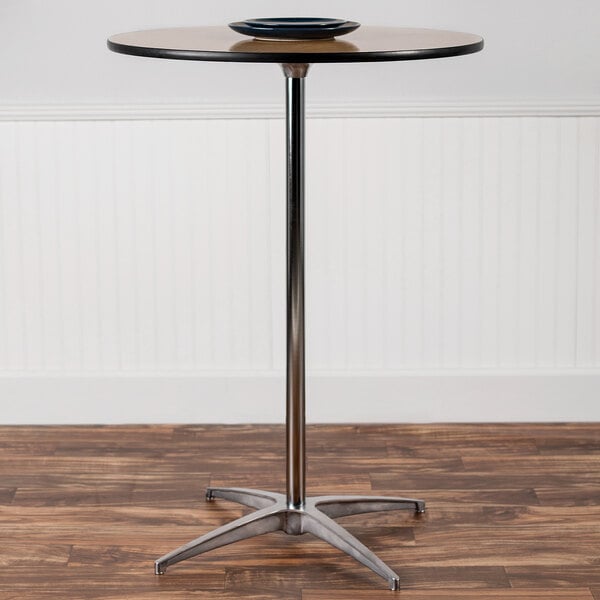 A Flash Furniture round birchwood cocktail table with a black bowl on top.