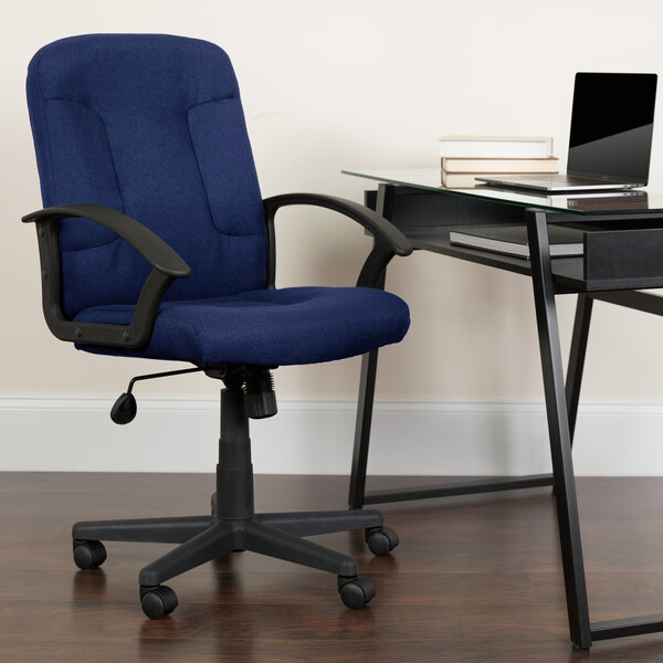 A blue Flash Furniture office chair with black armrests next to a glass desk with a laptop on it.