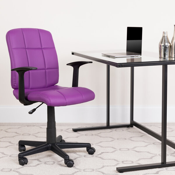 A Flash Furniture purple mid-back office chair with armrests next to a glass desk.