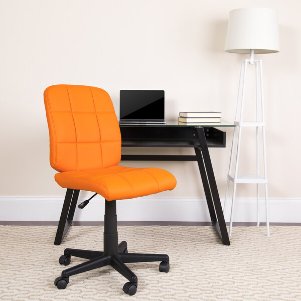 An orange Flash Furniture mid-back office chair in front of a desk.