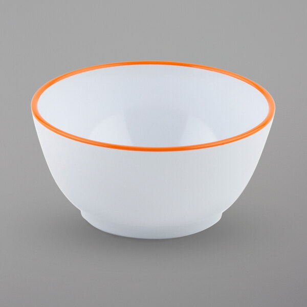 A close up of a GET white melamine bowl with a tangerine orange rim.