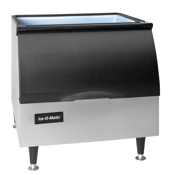 An Ice-O-Matic black and silver ice storage bin with a lid on a counter.
