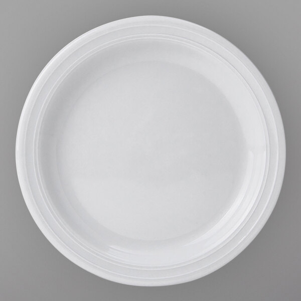 A close-up of a Tuxton Pacifica bright white narrow rim embossed china plate.