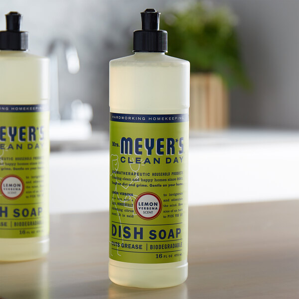 Two white bottles of Mrs. Meyer's Lemon Verbena scented dish soap on a counter.