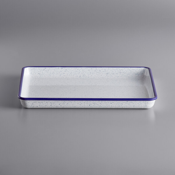 A white rectangular tray with a blue speckled border.