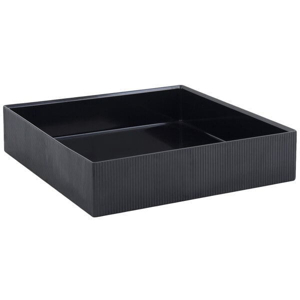 A black rectangular underliner for a cold wave platter on a table.