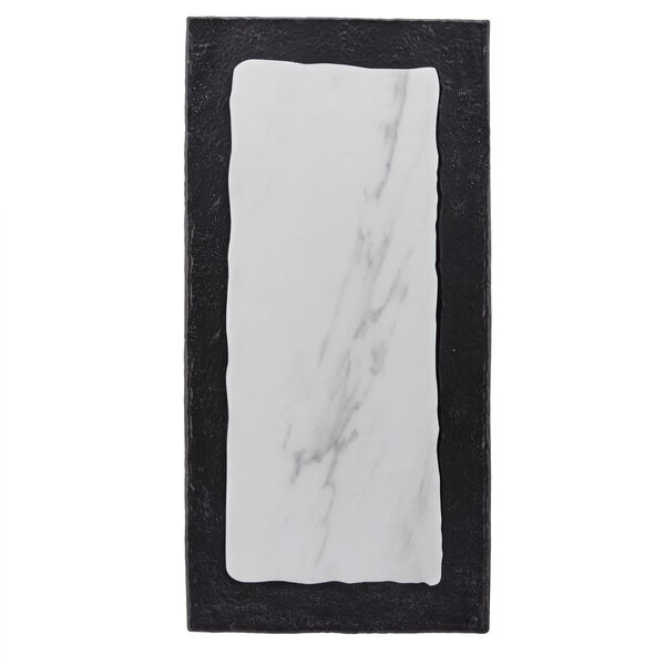 A rectangular white marble serving platter with a black border.