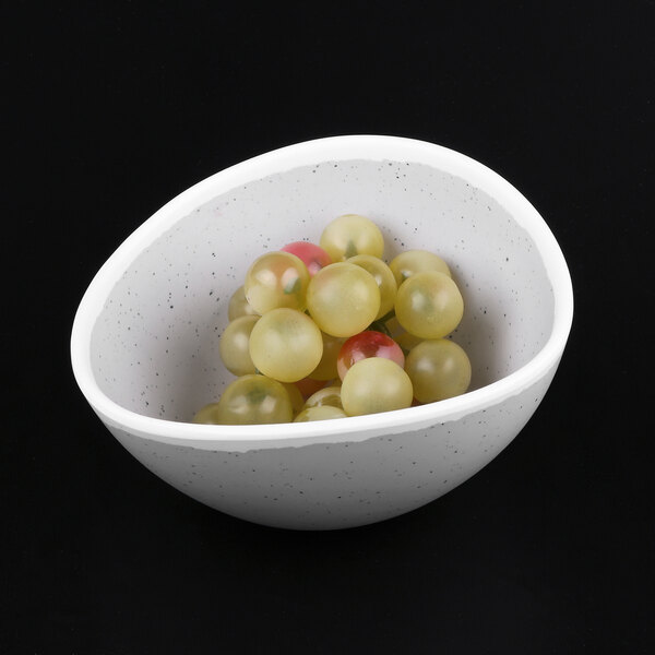 A gray speckled melamine bowl filled with grapes.