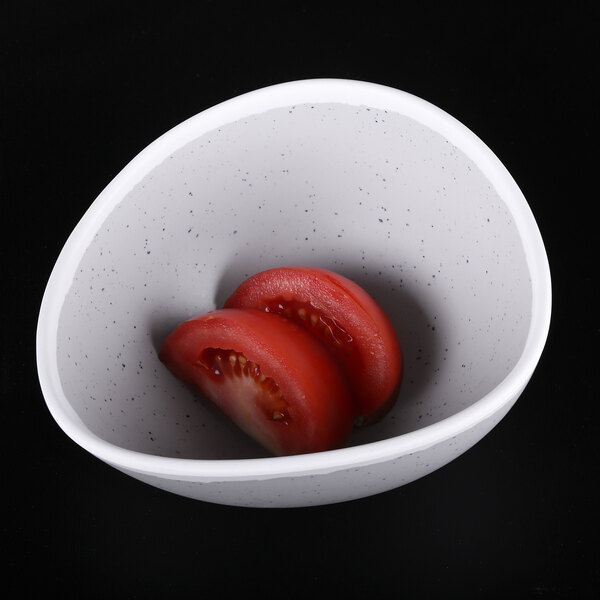 An Elite Global Solutions gray speckled melamine bowl filled with sliced tomatoes.