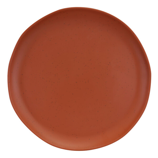 A close-up of an Elite Global Solutions Morocco round speckled matte sunburn terra cotta plate.