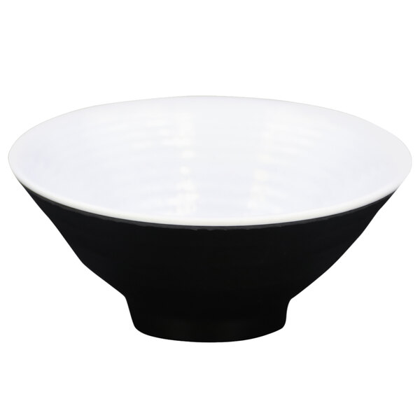 A black melamine bowl with a white rim.