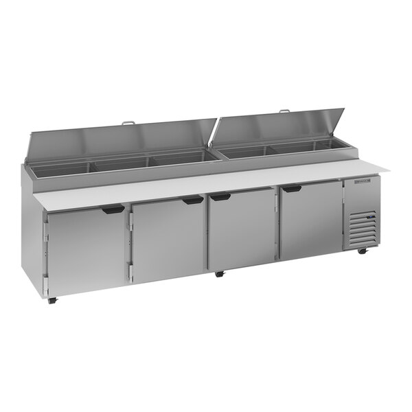 A silver Beverage-Air refrigerated pizza prep table with a stainless steel counter top and open lid.