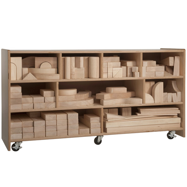 A Whitney Brothers wooden storage cart with shelves holding blocks of different shapes and sizes.