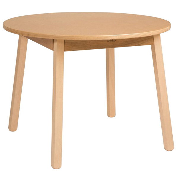 A Whitney Brothers round wooden children's table with legs.