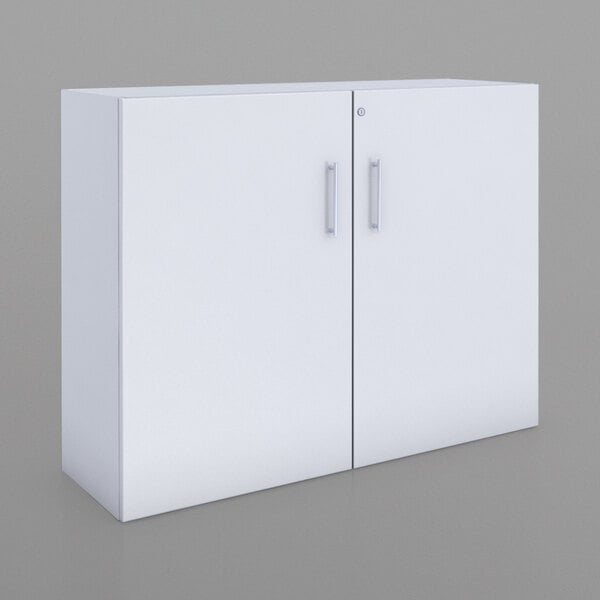 A Whitney White melamine storage cabinet with silver handles.