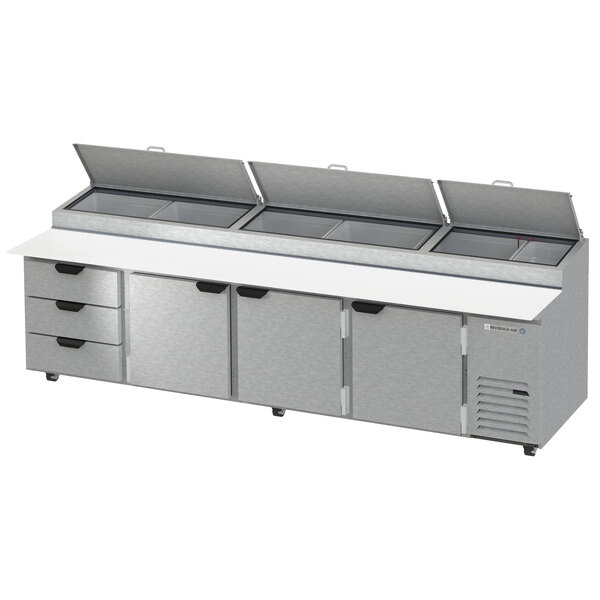 A Beverage-Air pizza prep table with a stainless steel counter top and three drawers.