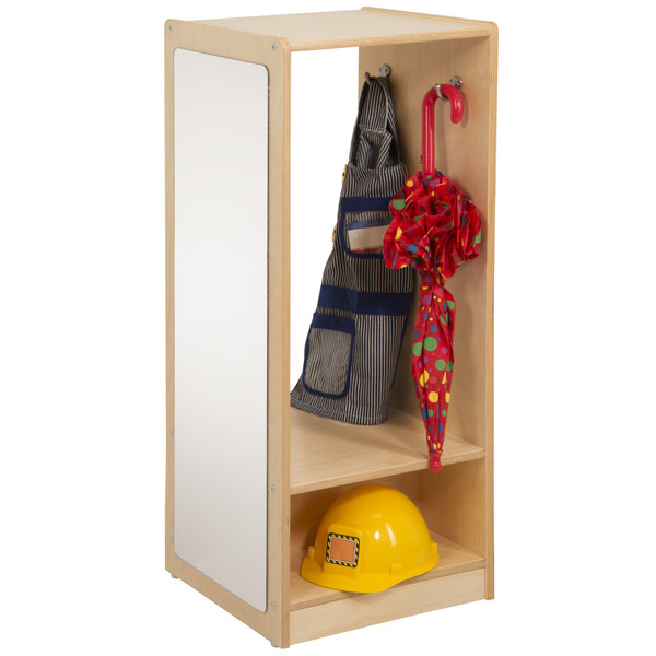 A Whitney Brothers wooden dress-up center with a hat and a tool on a shelf.