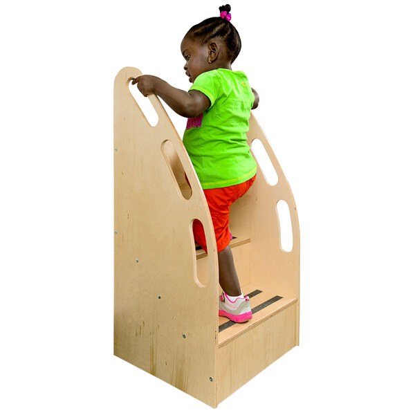 A child climbing up Whitney Brothers wooden step stairs.