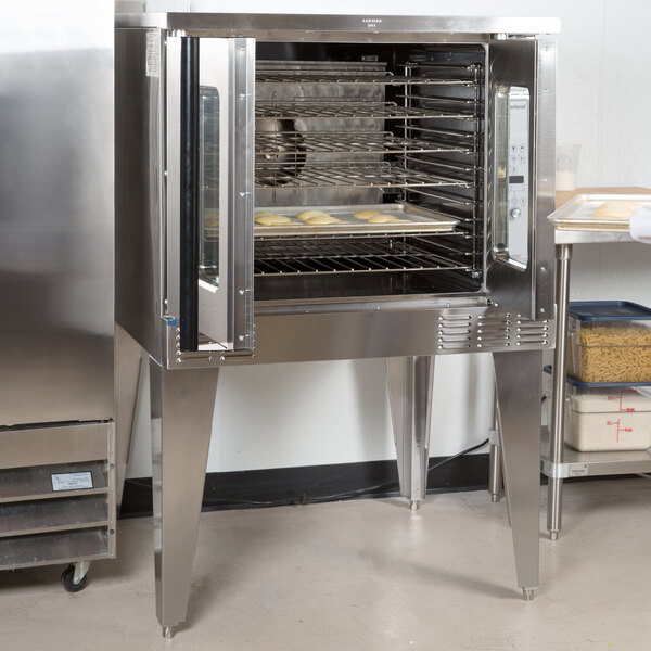 A stainless steel Garland convection oven with food inside.