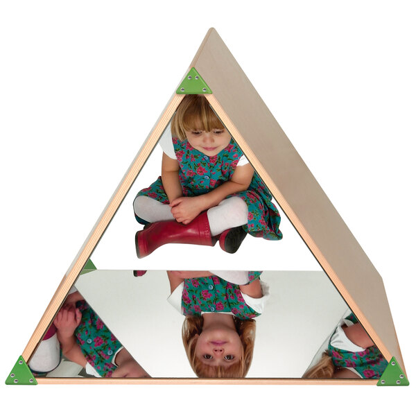 A girl sitting inside a triangular wood mirror tent.