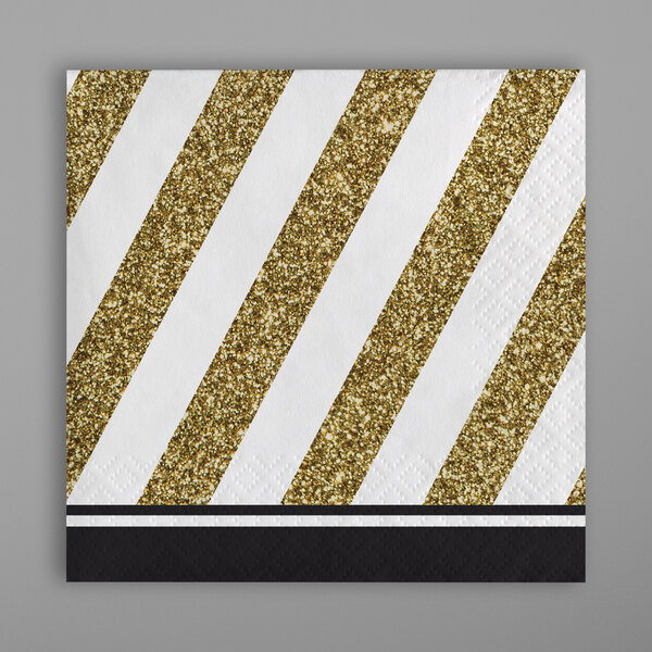A black napkin with gold stripes.