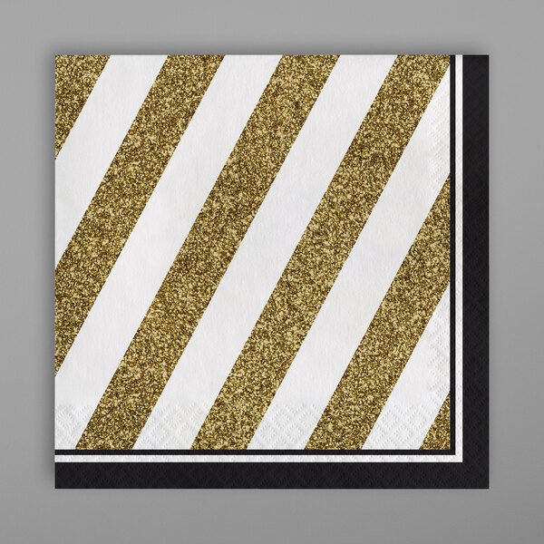 A black paper napkin with gold stripes.