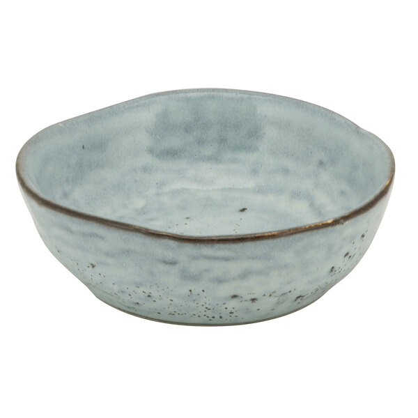A close up of a 10 Strawberry Street blue porcelain coupe snack bowl with a speckled surface.