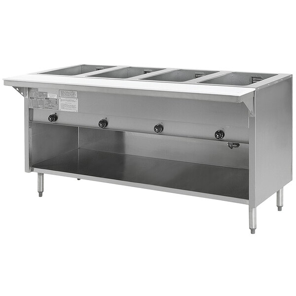 An Eagle Group stainless steel electric hot food table with open front and four pans on a counter.