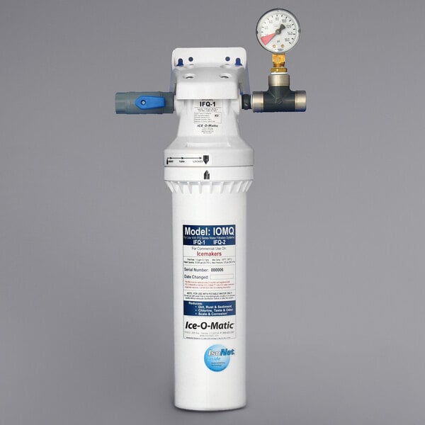 A white Ice-O-Matic water filter with a pressure gauge.