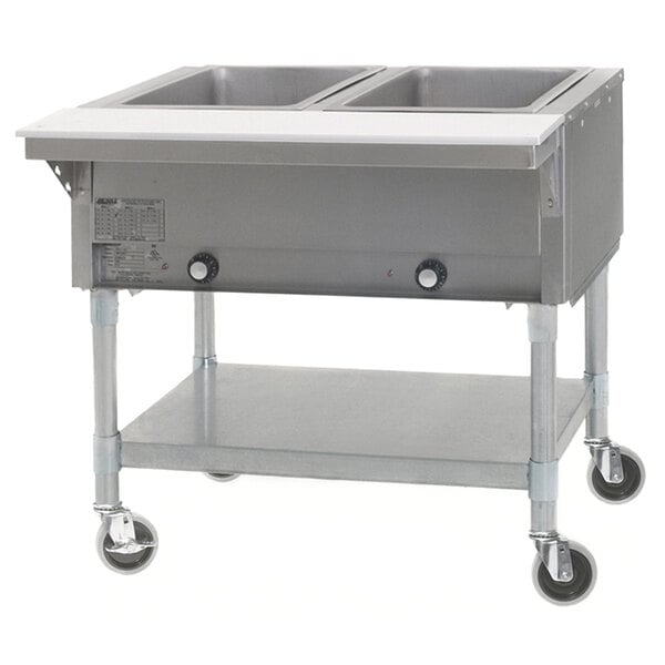 An Eagle Group commercial hot food table with a galvanized open base and two pans on wheels.
