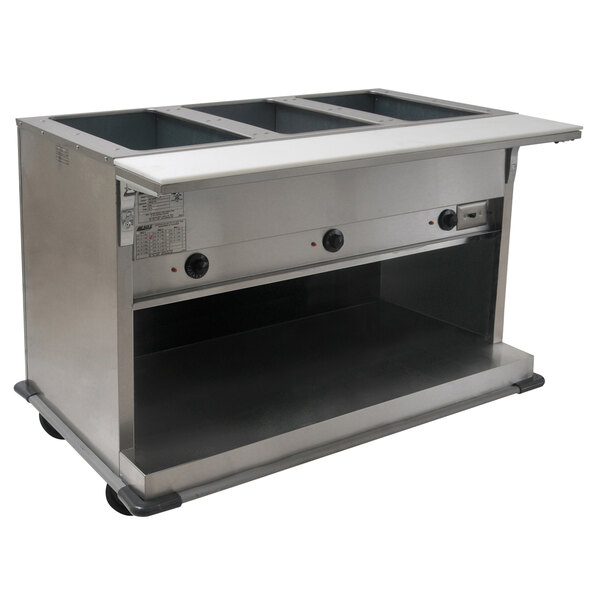 A stainless steel Eagle Group hot food table with three open wells on a school kitchen counter.