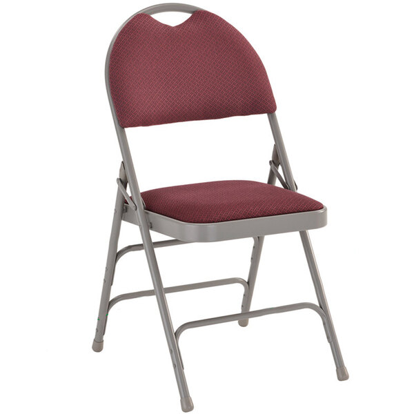 A burgundy metal folding chair with a padded fabric seat.