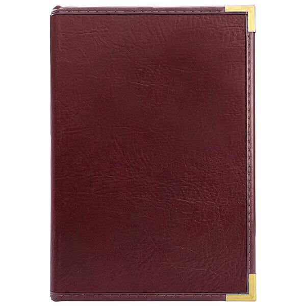 A red leather H. Risch, Inc. Seville menu cover with gold corners.
