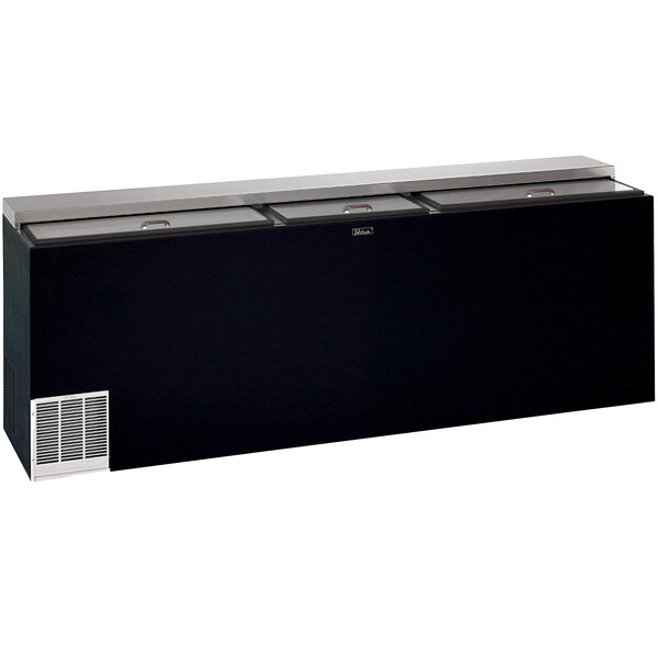 A black Perlick horizontal flat top bottle cooler on a counter.