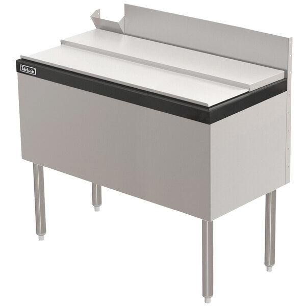 A stainless steel Perlick underbar ice chest with a black top.