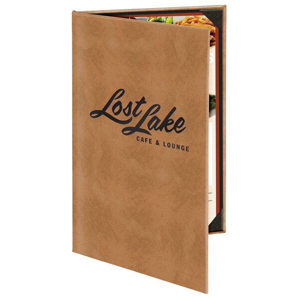 A brown leather Menu Solutions Kensington menu cover on a table with a menu inside that says "Lost Lake Restaurant"