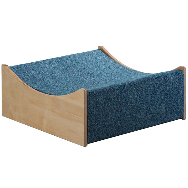 A blue and green wooden Whitney Brothers Children's Woodscapes Valley platform with carpet.