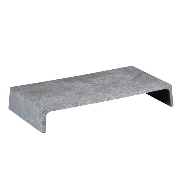 A grey rectangular American Metalcraft faux greystone melamine riser with a curved edge on a metal base.